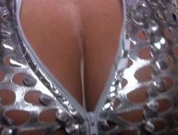 Steve Holmes enjoys in getting his hands on a hot pornstar babe in a silver provocative outfit and gets to peak into her meatballs a bit with his camera